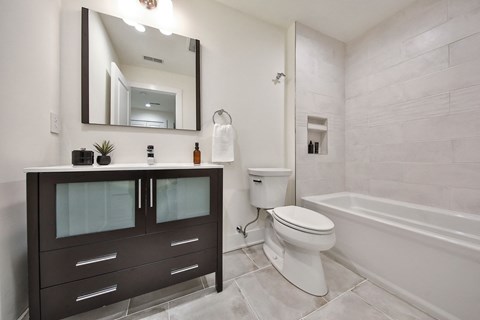 a bathroom with a toilet and a sink and a bath tub