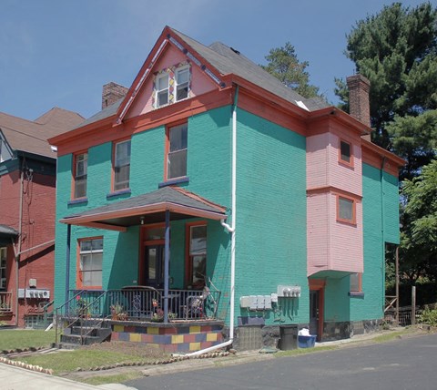 a colorful house on the corner of a street
