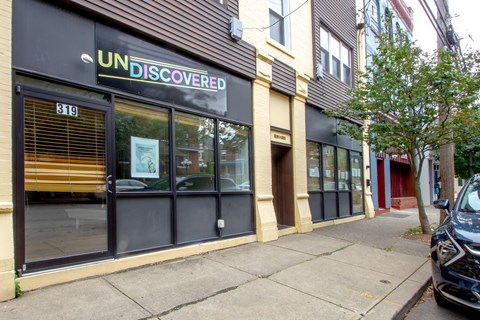 A storefront with the name UNDISCOVERED on the top of the windows.