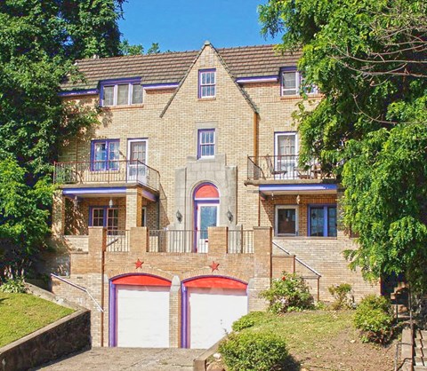 a large brick house with two garage doors