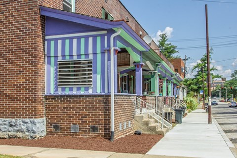 A building with a purple and green striped awning.