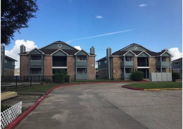 an empty street in front of an apartment building