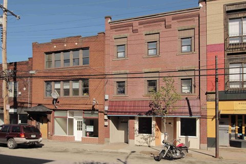 a red brick building with a motorcycle parked in front of it
