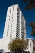 A tall white building with a lot of windows.