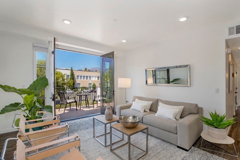 a living room with a couch and a door to a patio