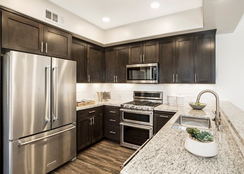 a kitchen with stainless steel appliances and granite counter tops