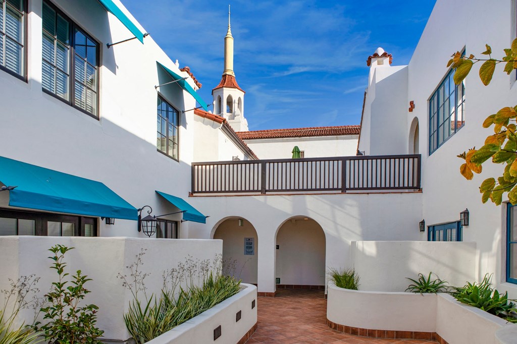 a white building with a church in the background