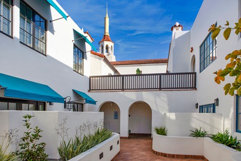 a white building with a church in the background