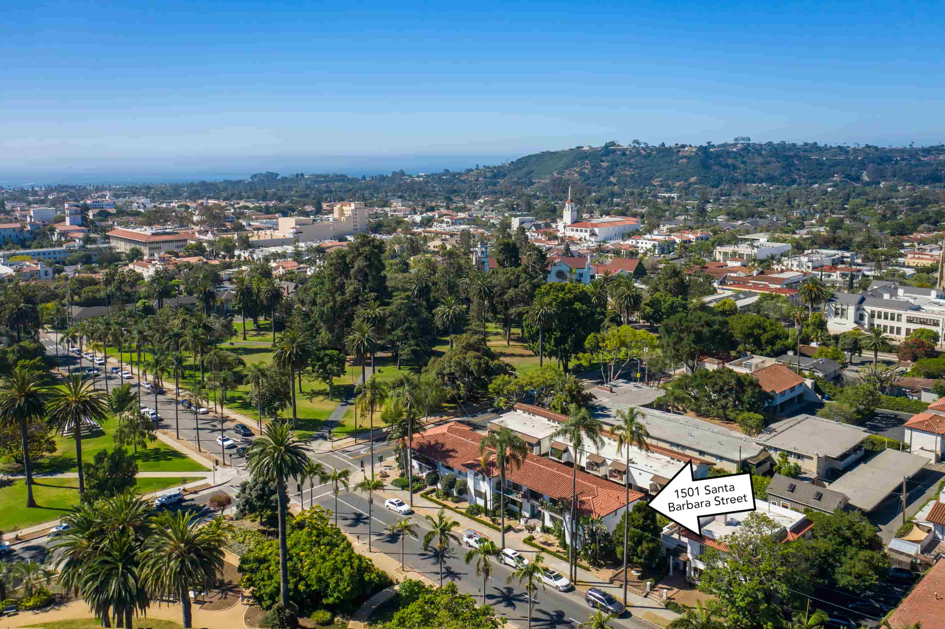 A street view of a residential area with a sign that reads "1501 Santa Barbara Street".