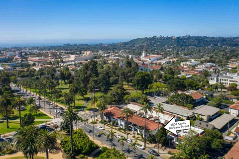 A street view of a residential area with a sign that reads "1501 Santa Barbara Street".