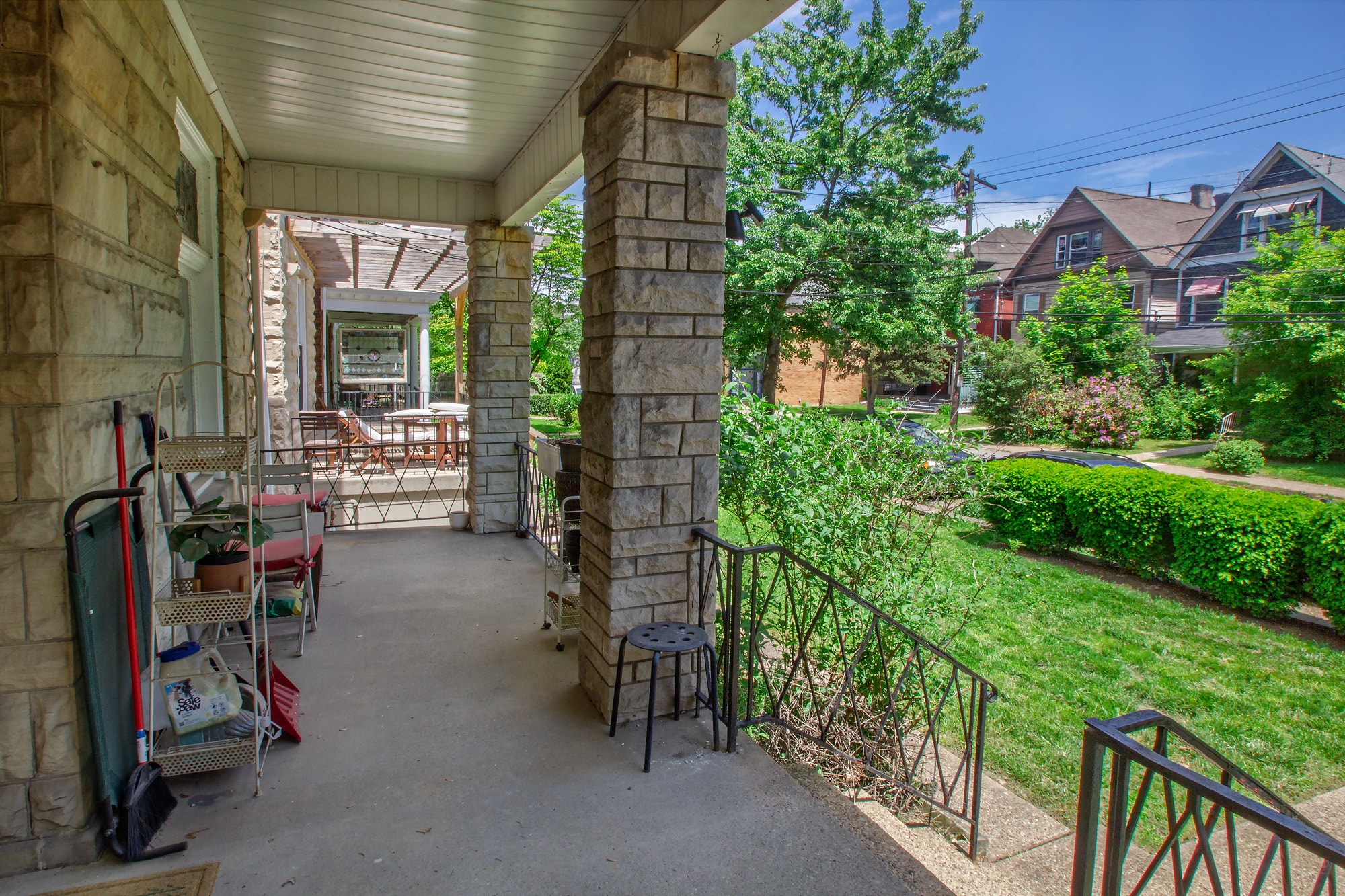 A patio with a table and chairs is surrounded by a stone wall.