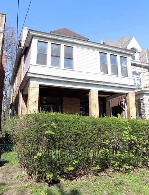 A house with a white garage door and a brown roof.