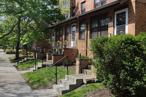 A red brick house with a white door and windows.