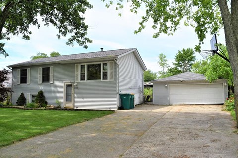 a white house with a garage and a driveway