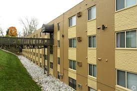 a row of apartment buildings with a bridge