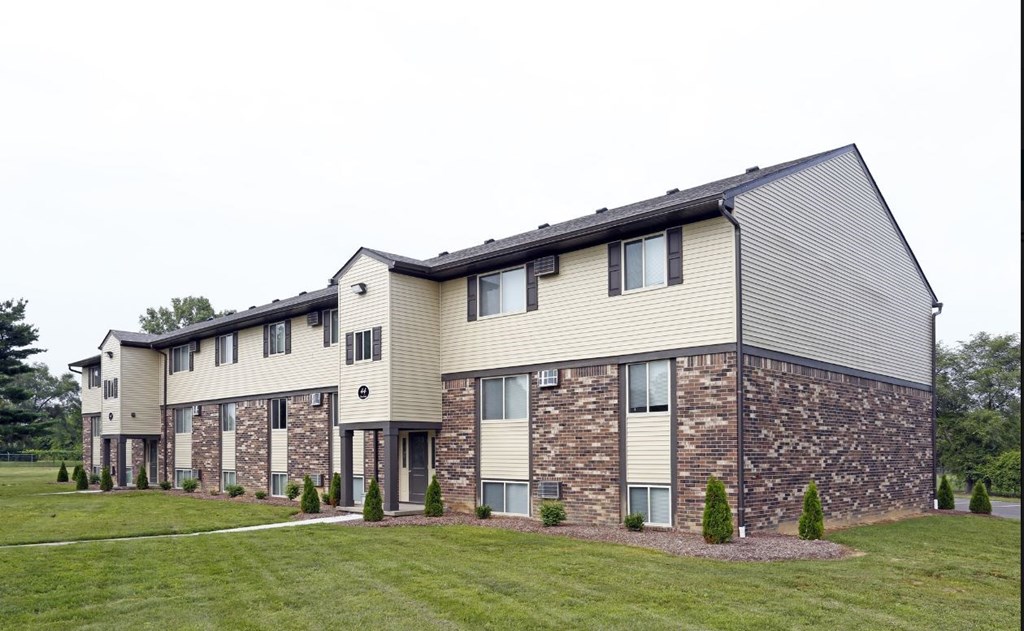 an apartment building with stone and wood siding