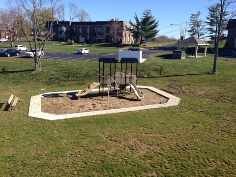 a playground in a park with a swing set