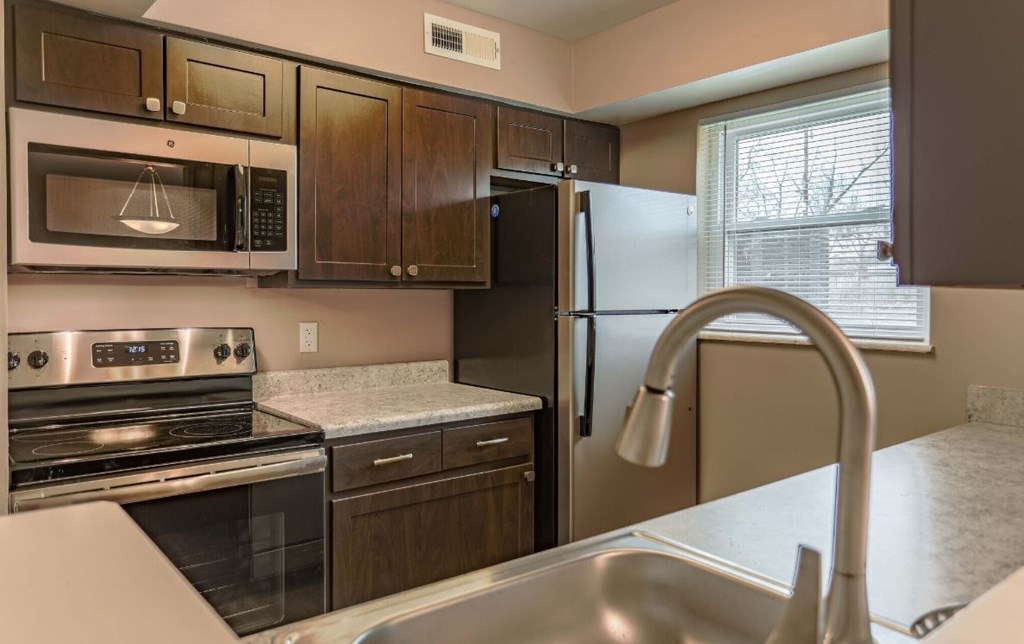 a kitchen with a sink and a refrigerator