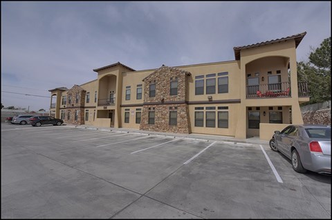 A large building with a parking lot in front of it.