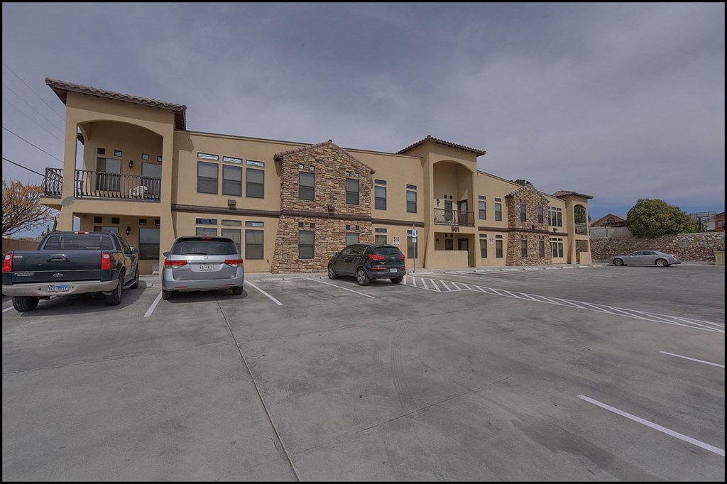 a parking lot with cars in front of a building