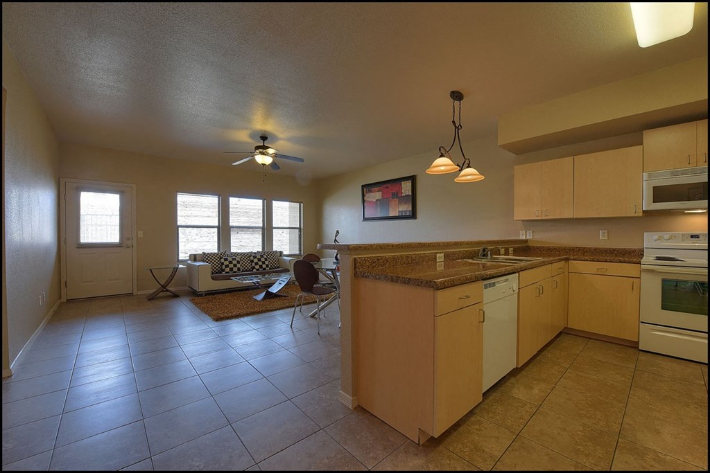 a kitchen and living room with an open floor plan