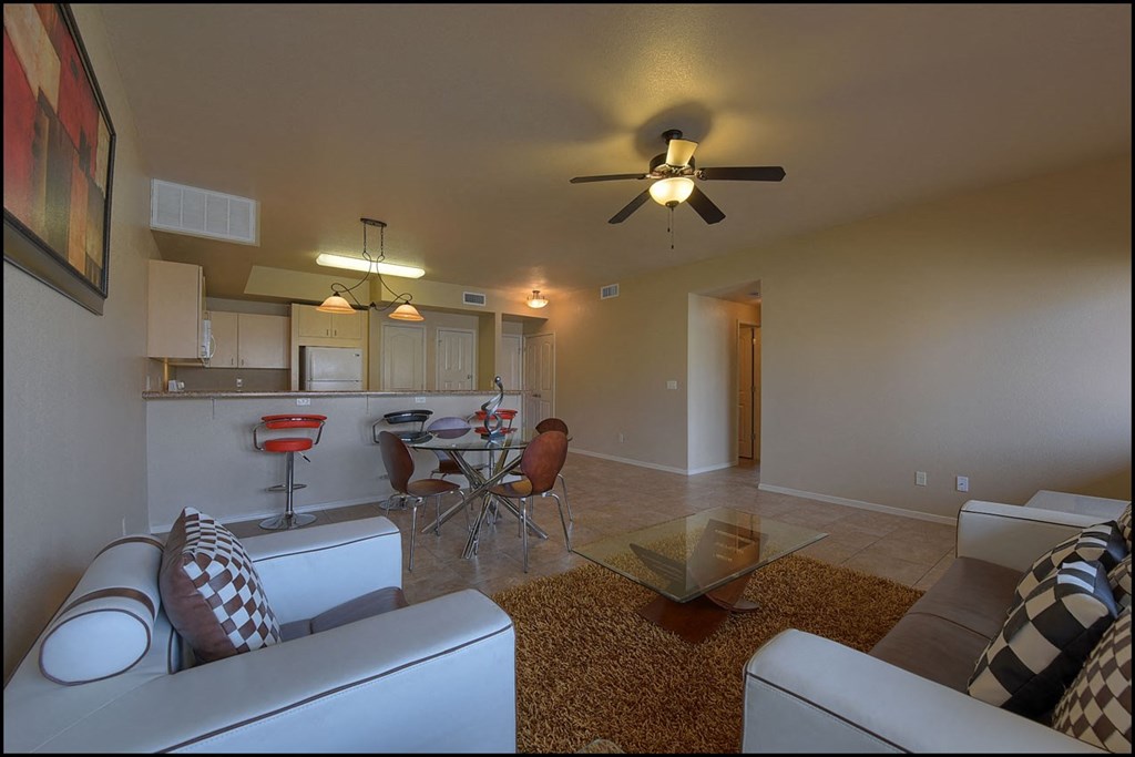 a living room and kitchen with a ceiling fan