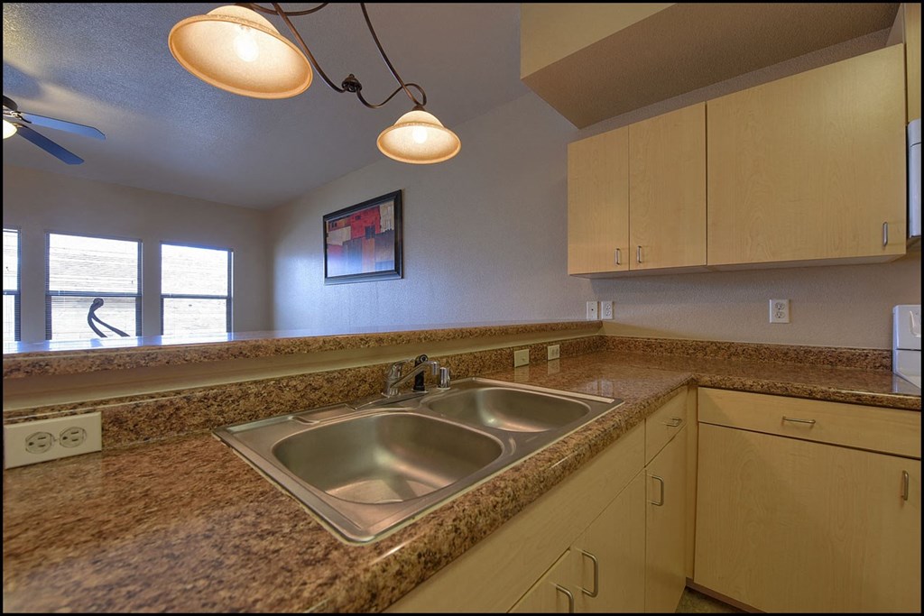 a kitchen with granite counter tops and a sink