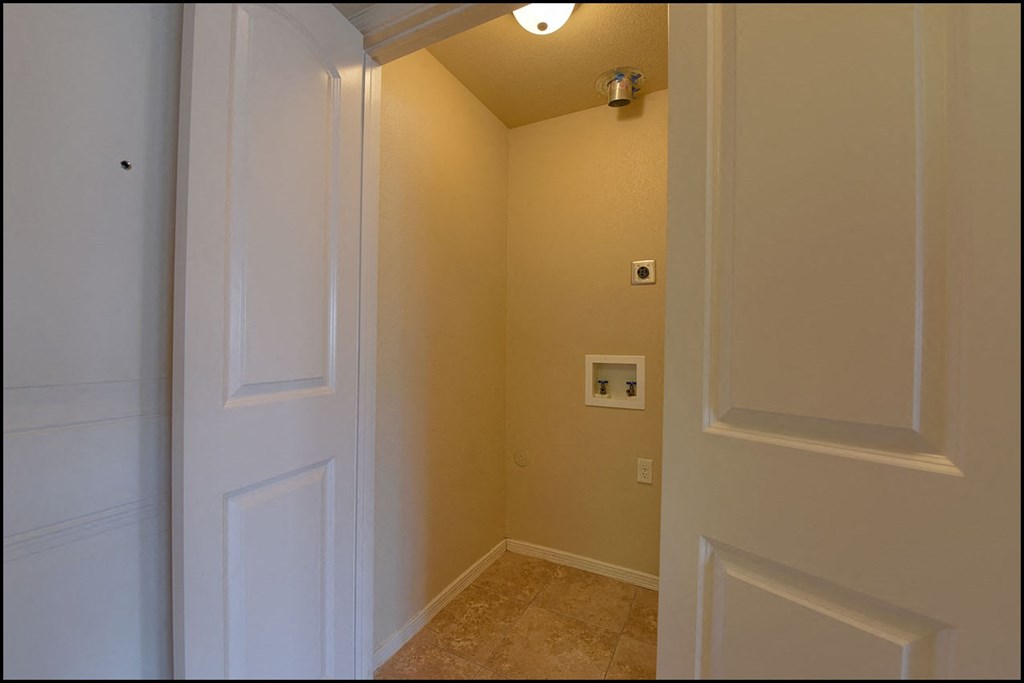 a hallway with a white door and a light on the ceiling