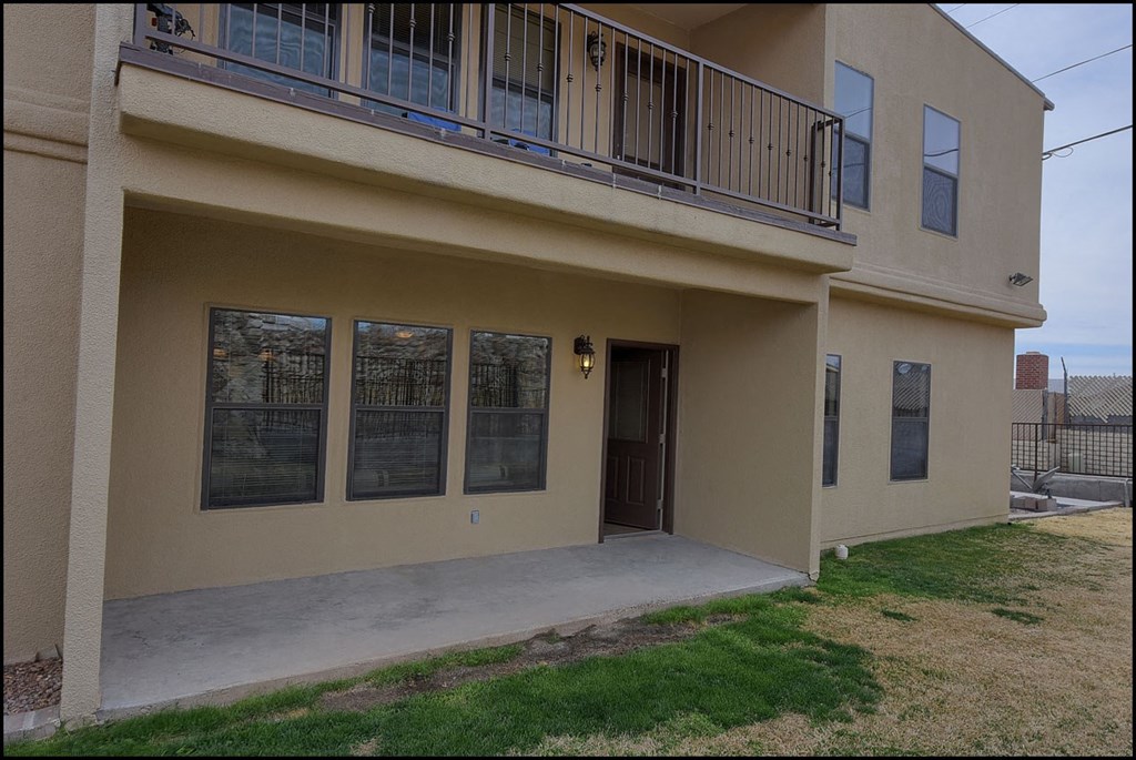 a front view of a house with a porch and a balcony