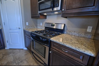 a kitchen with stainless steel appliances and granite counter tops