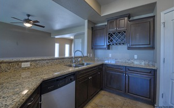 a kitchen with a granite counter top and a sink