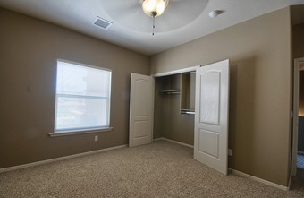 a empty room with an open door and a window