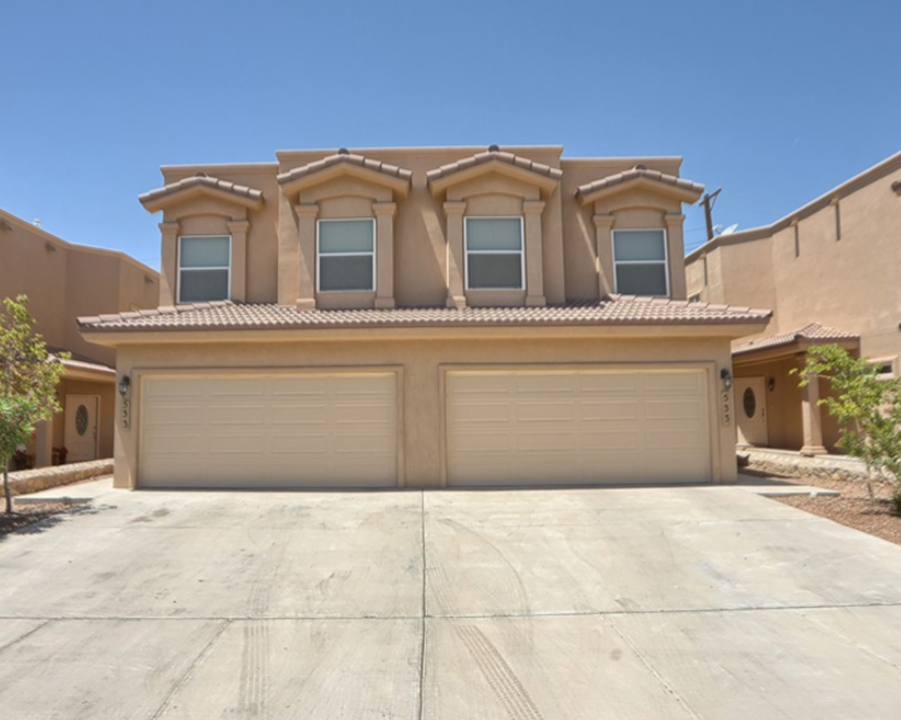 a house with a garage door in front of it