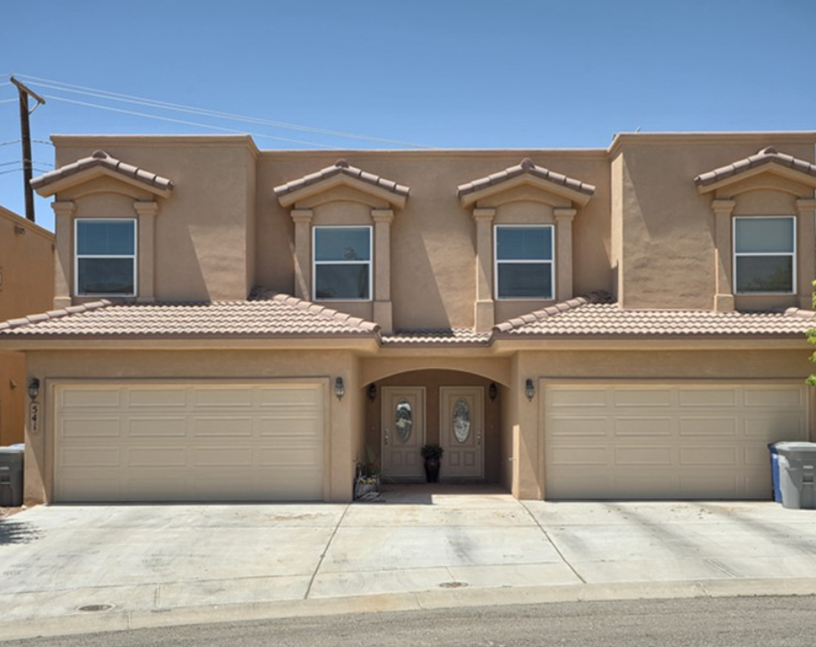 a house with three garage doors in front of it