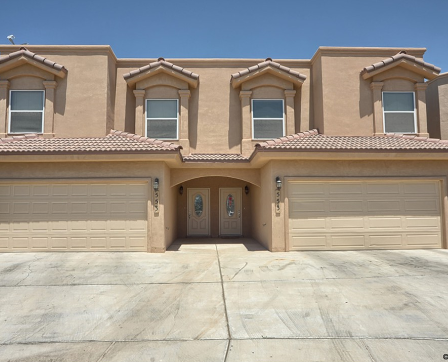 a house with two garage doors in front of it