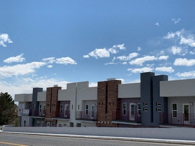 a row of buildings with a street in front of them