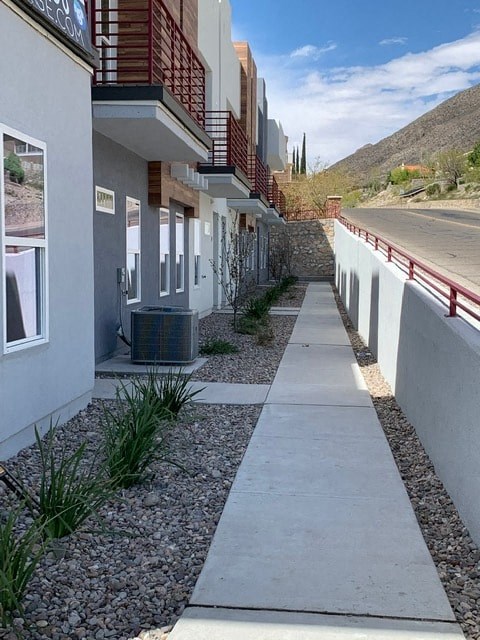 a sidewalk in front of a building next to a road