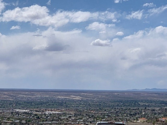 a view of the city and the clouds in the sky