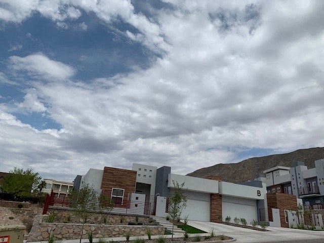 a group of buildings in front of a cloudy sky