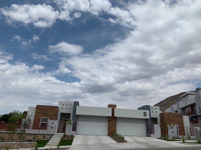 a building with a cloudy blue sky above it