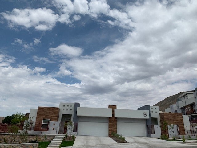 a building with a cloudy blue sky above it