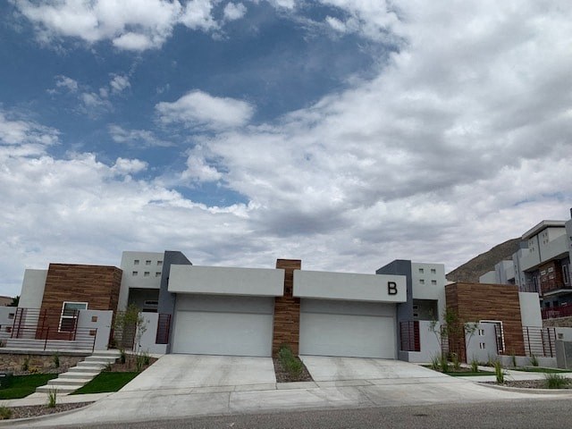 a white building with a cloudy sky in the background