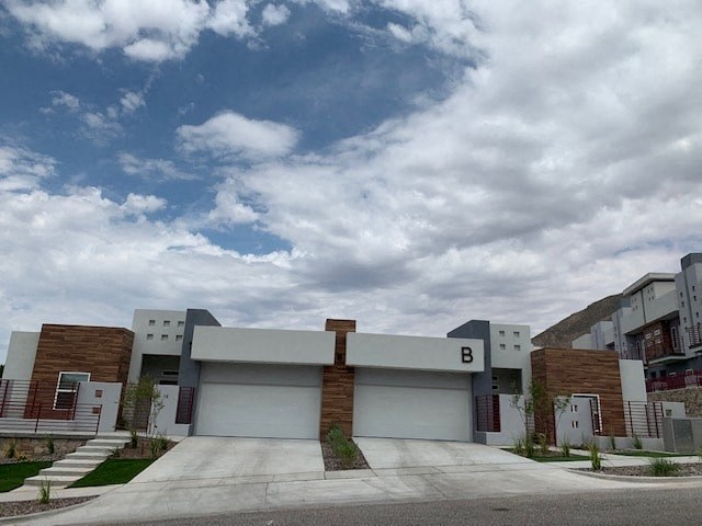 a white building with a cloudy sky in the background