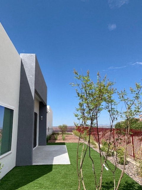 the backyard of a house with a yard and a fence