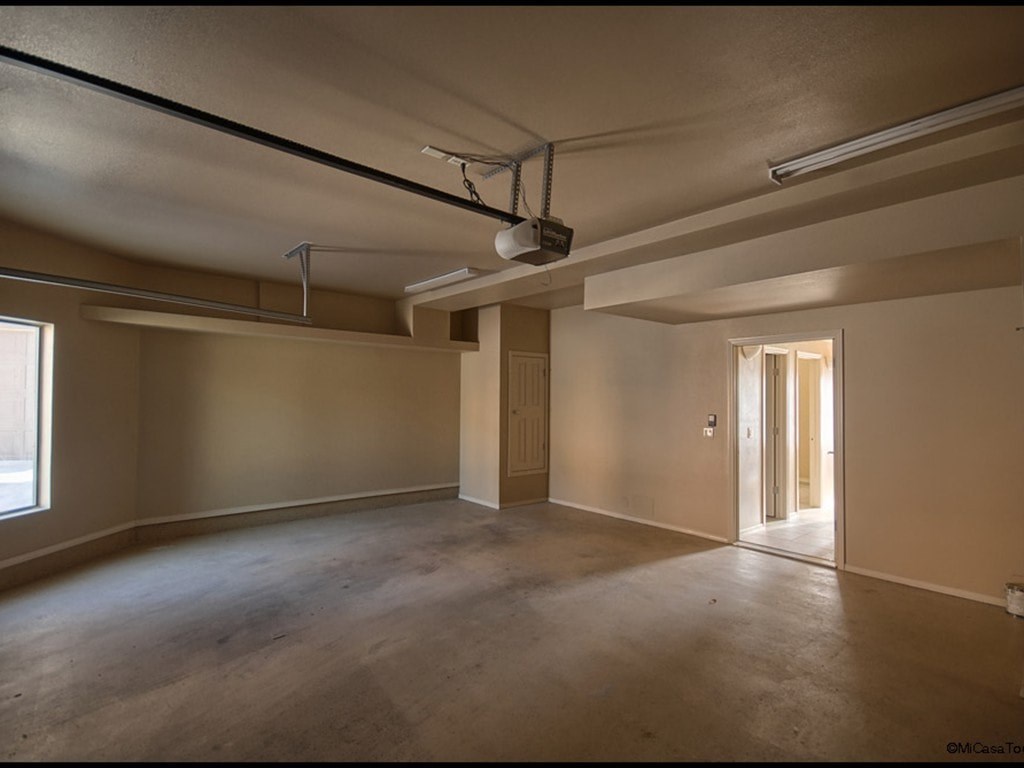 A large empty room with a doorway leading to another room.