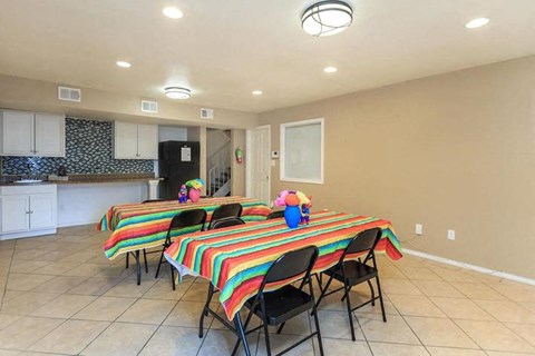 A dining room with a table set for a meal.