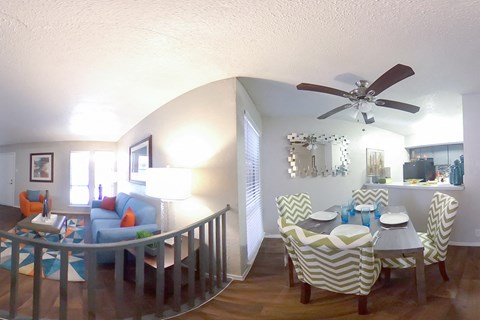 A dining room with a table set for four.