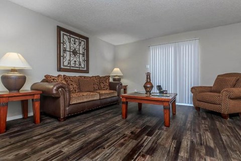 A living room with brown leather furniture and a wooden coffee table.
