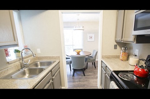 A kitchen with a table and chairs in the middle of the room.