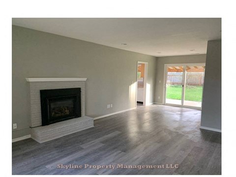 an empty living room with a fireplace